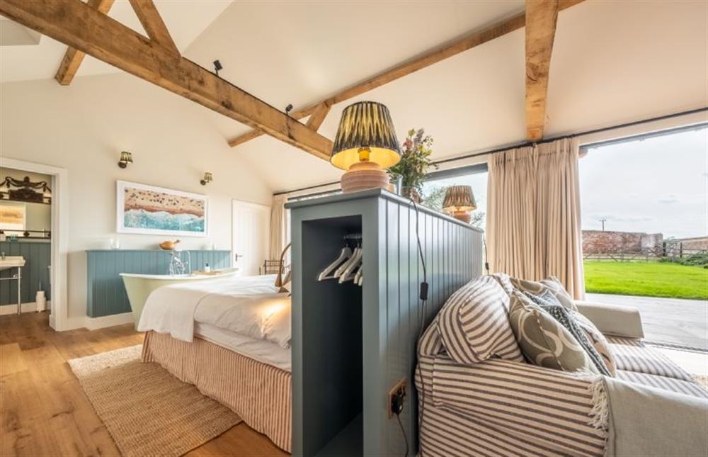 Ground floor: Bedroom area with door to shower room at The Goat Shed, Thompson near Thetford