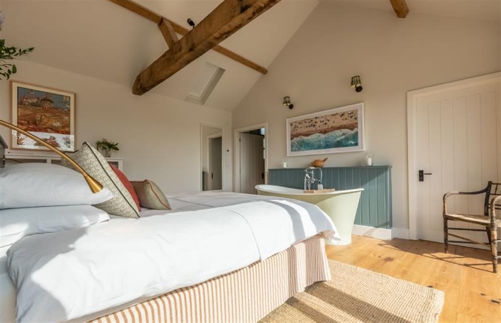 Ground floor: Bedroom with super-king bed and slipper bath at The Goat Shed, Thompson near Thetford