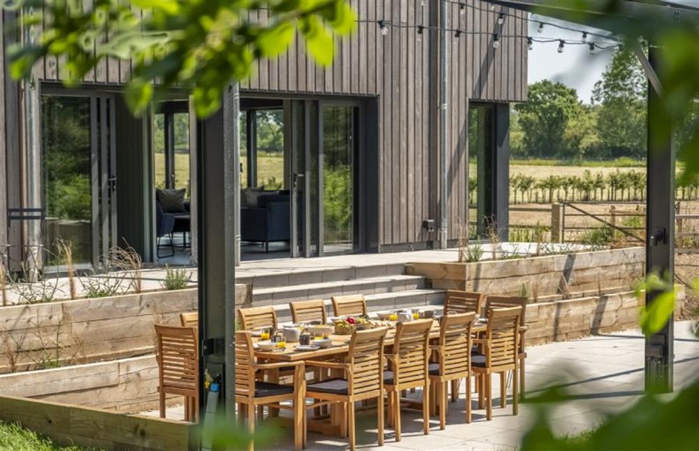 A garden view of the barn and dining area at The Grain Store, Reepham