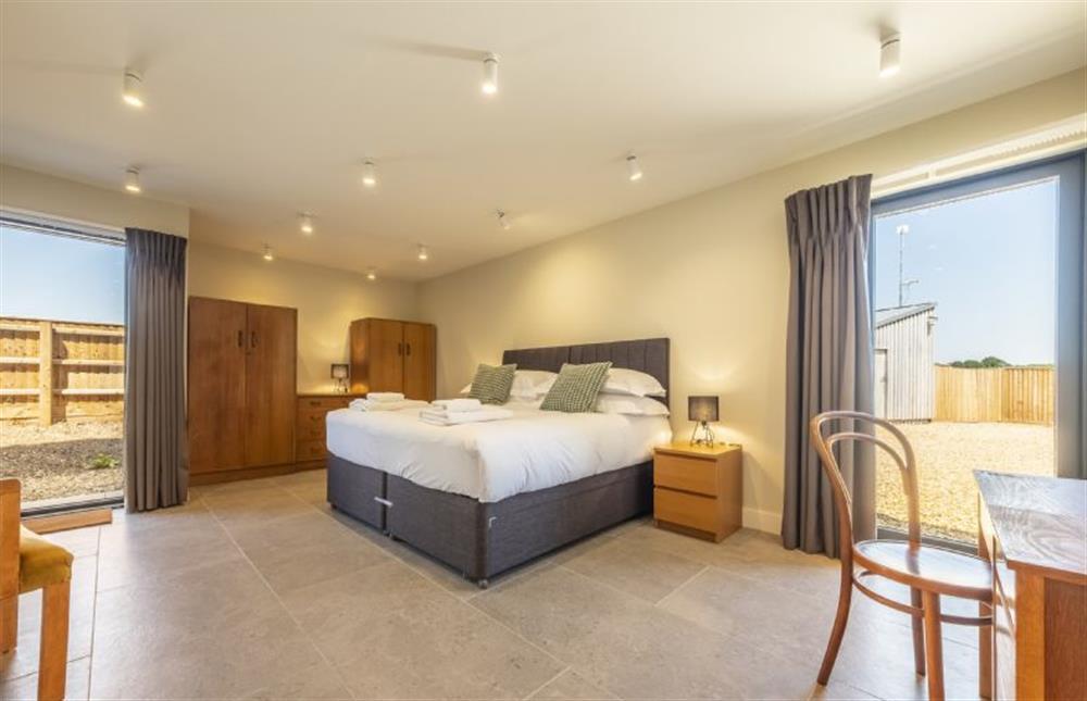 Bedroom five with 6’ super-king size bed at The Grain Store, Reepham