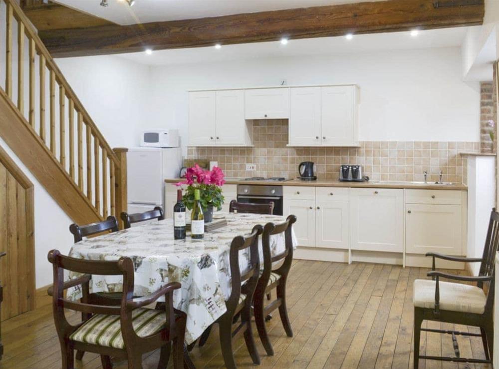 Well-equipped fitted kitchen with convenient dining area at The Granary Barn in North Willingham, near Market Rasen, Lincolnshire