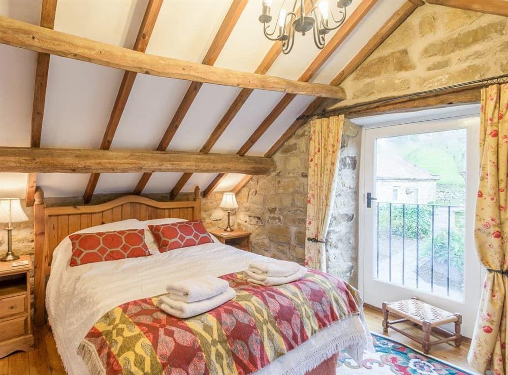 Double bedroom with beamed ceiling at The Granary in Bilsdale, near Helmsley, North Yorkshire