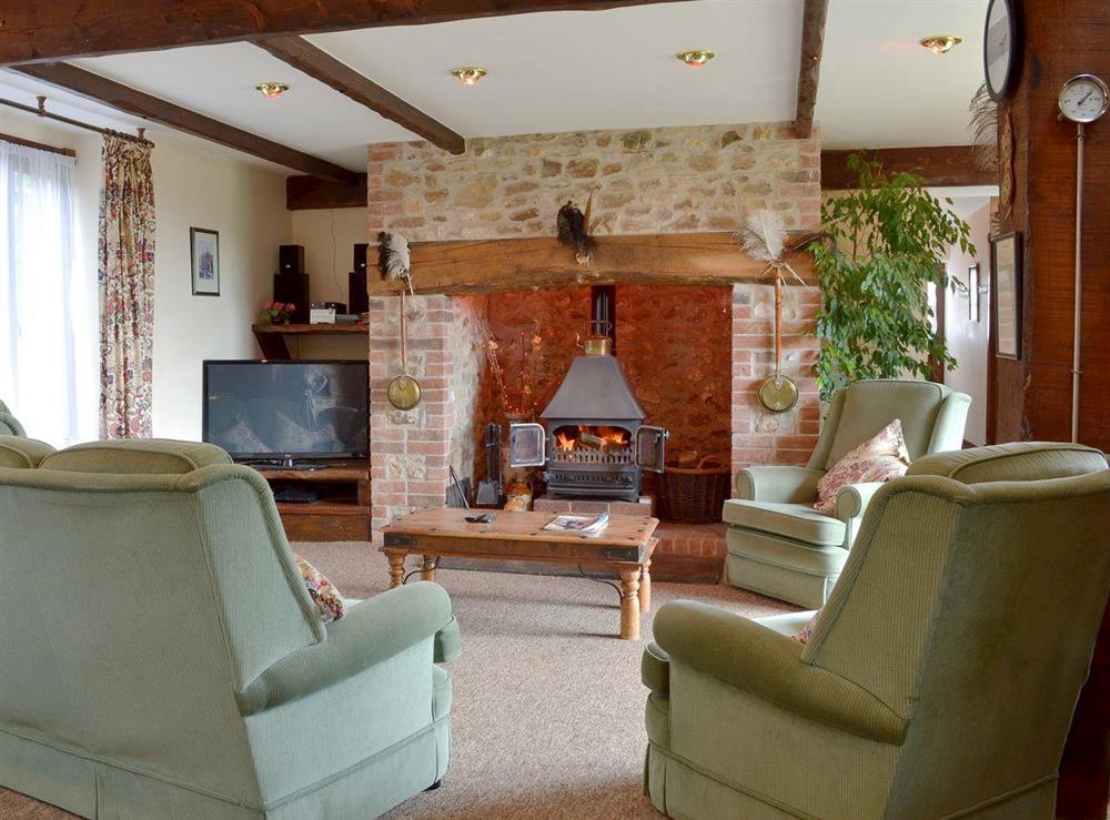 Cosy living area with woodburner at The Granary in Colyford, near Seaton, Devon