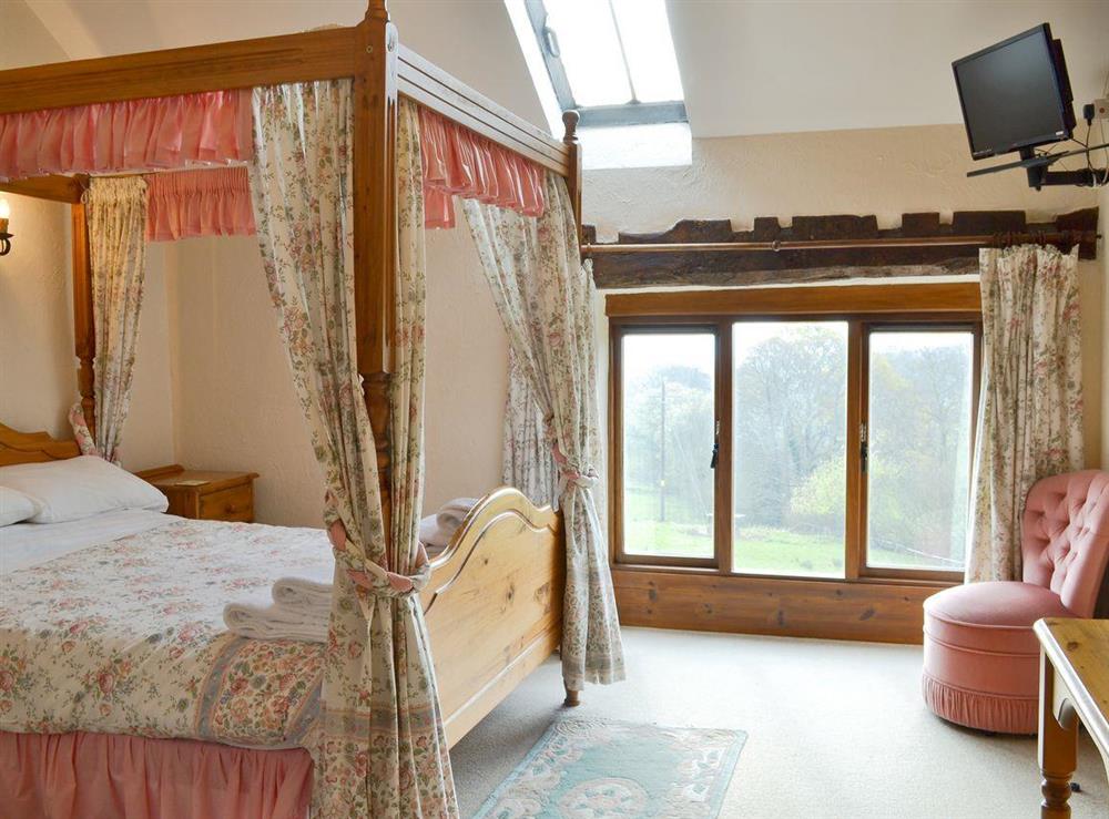 Large, spacious bedroom with a four poster bed at The Granary in Colyford, near Seaton, Devon