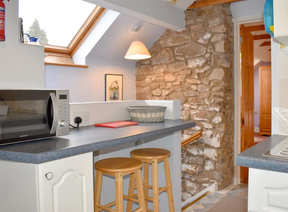 Kitchen area with breakfast bar (photo 2) at The Granary in Huntley, Gloucestershire