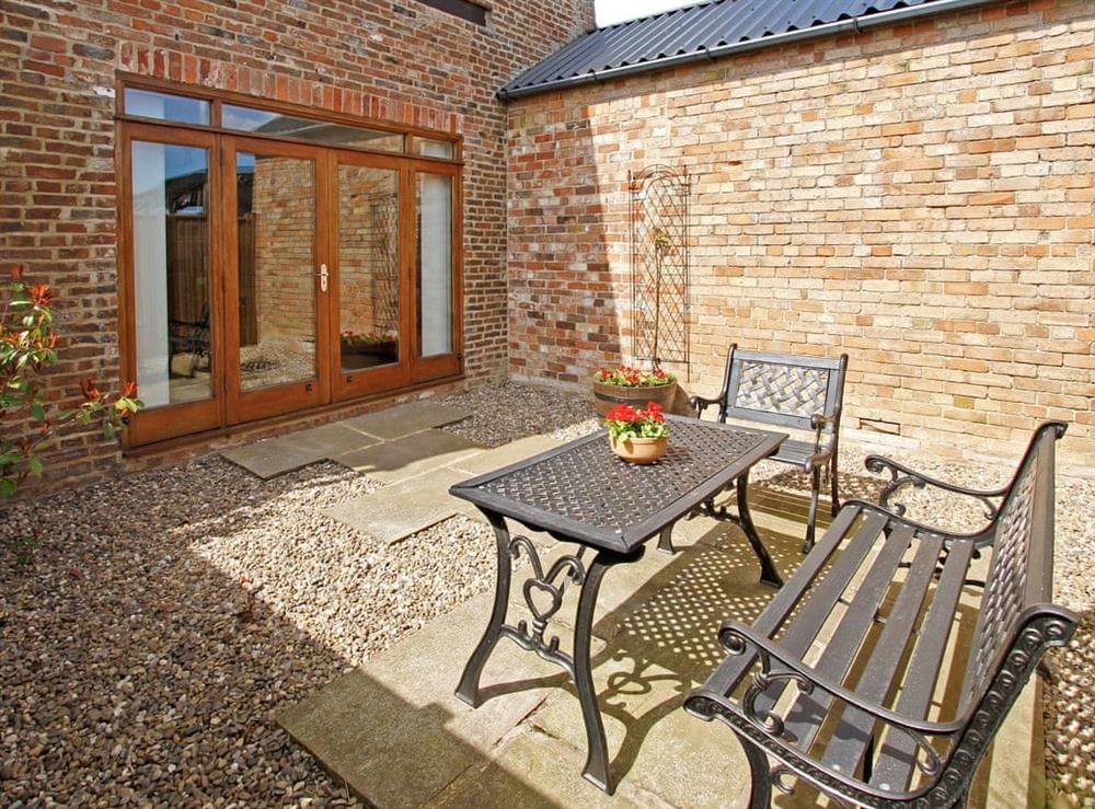 Enclosed private patio area with outdoor furniture