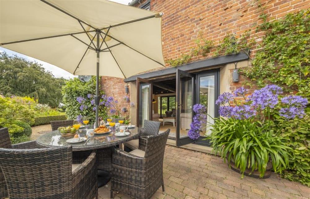 Pretty courtyard garden that is accessible from the kitchen and the sitting room at The Granary, Oulton near Norwich