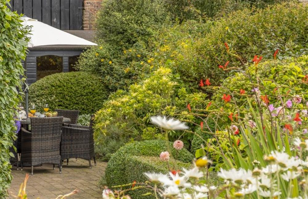 Pretty courtyard garden with dining set and parasol (photo 2) at The Granary, Oulton near Norwich