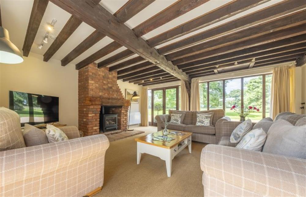 Sitting room with plenty of windows that look out onto green surroundings at The Granary, Oulton near Norwich