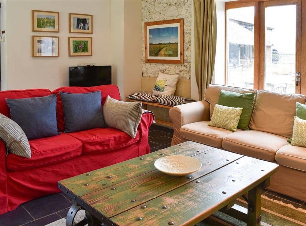 Welcoming living room with comfortable sofas at The Granary in Oxborough, Norfolk., Great Britain