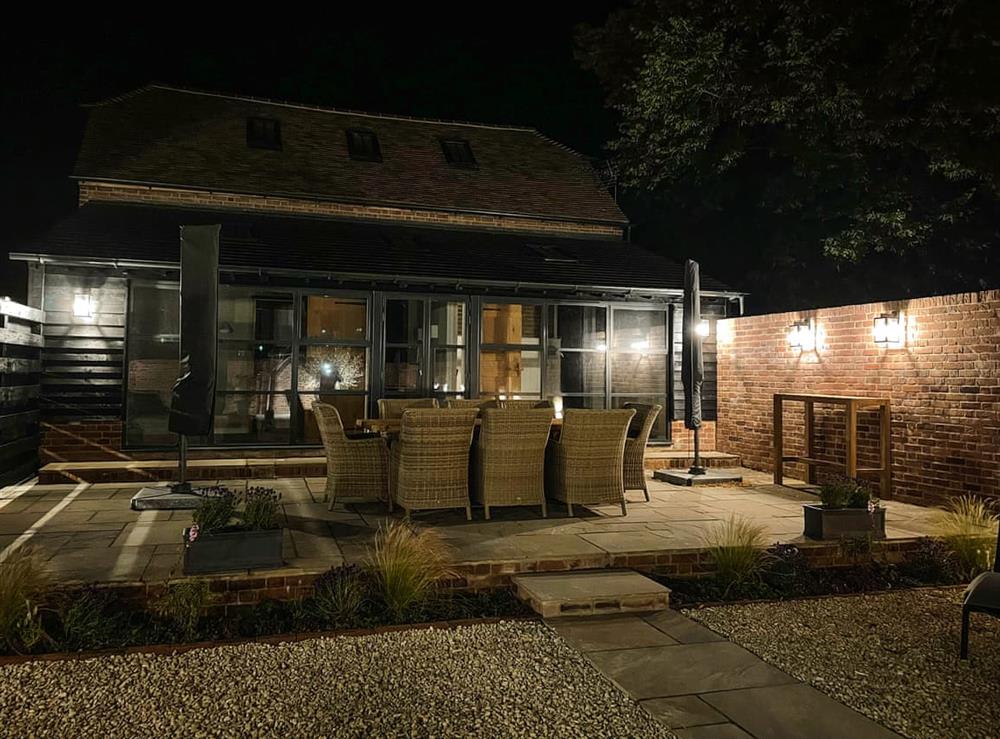 Outdoor area illuminated at night at The Granary in Peasmarsh, East Sussex