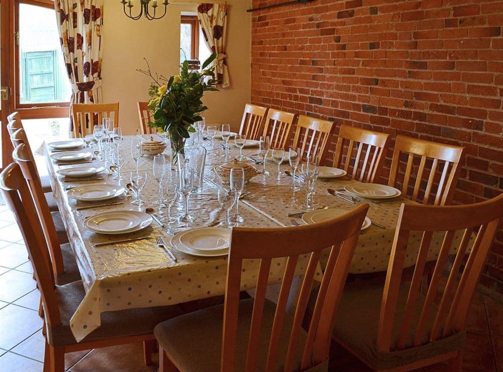 The huge kitchen dining table seats up to fourteen guests at The Granary in Somersal Herbert, Ashbourne, Derbyshire