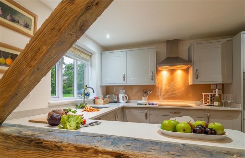 Traditional beams and views of the kitchen area at The Granary, Woodbridge