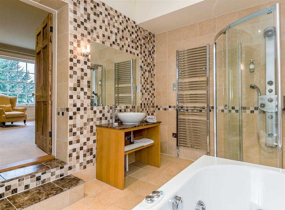 En-suite bathroom with bath, separate shower cubicle at The Grange Farmhouse in Sculthorpe, Norfolk