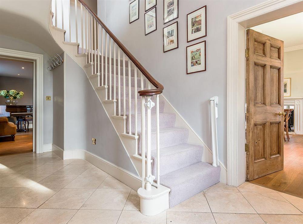 Entrance hall with an elegant staircase at The Grange Farmhouse in Sculthorpe, Norfolk