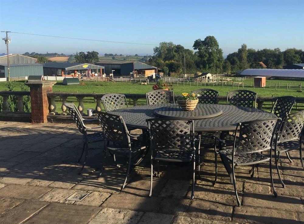 Paved patio area with outdoor furniture at The Grange in Hope-under-Dinmore, near Leominster, Herefordshire