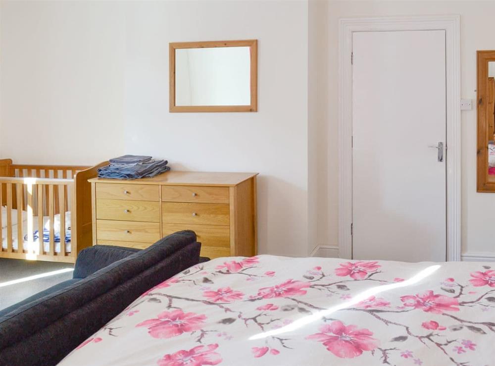 Double bedroom with cot at The Harbour Masters House in Bridlington, North Humberside