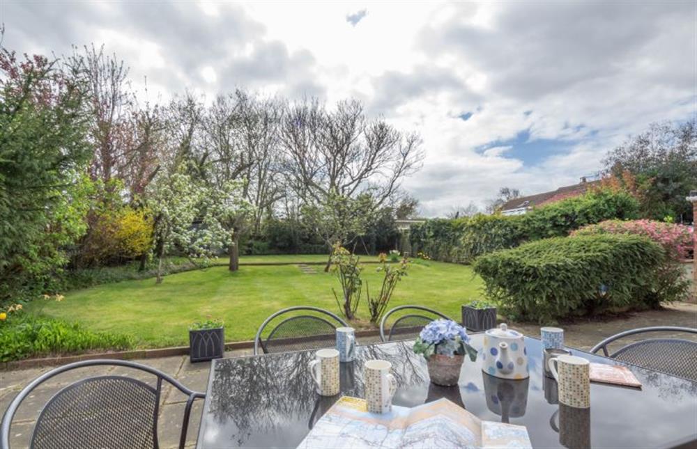 Garden with patio, table and seating for six at The Hares, Brancaster near Kings Lynn