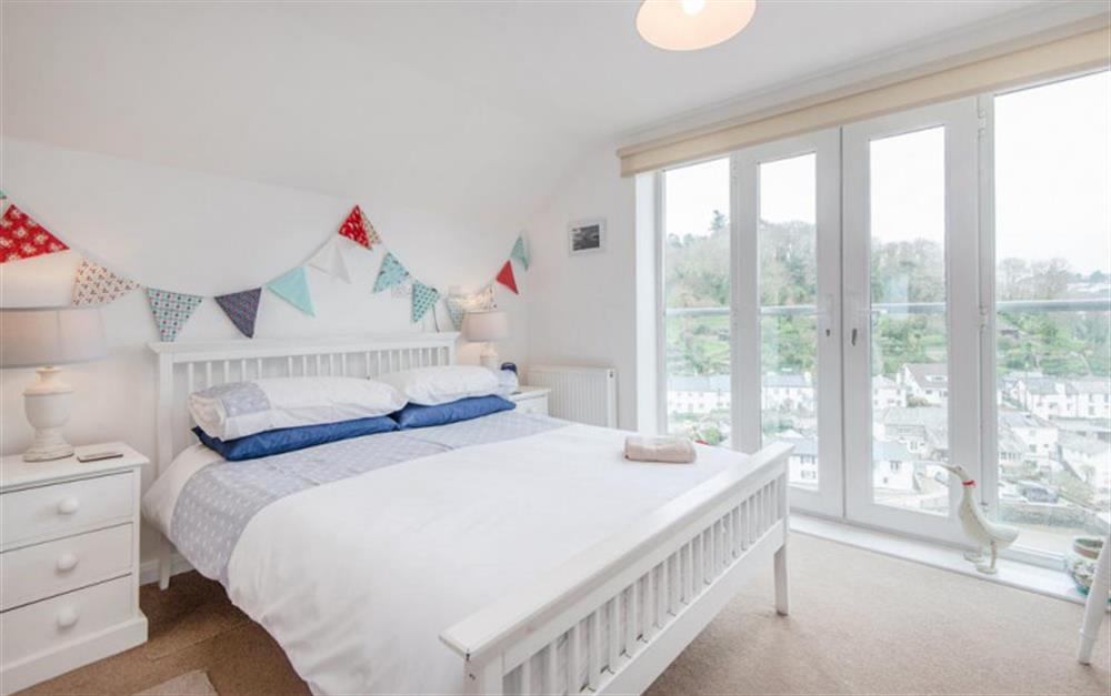 Beautiful master bedroom with waterside view at The Haven in Noss Mayo
