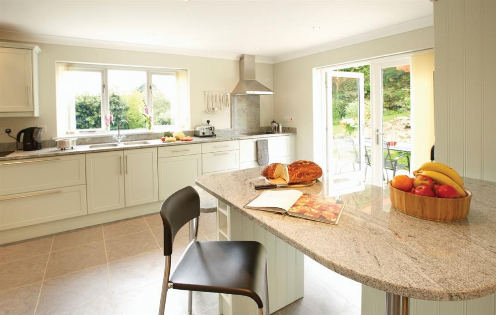 Open-plan kitchen/dining and snug area. The snug has double patio doors onto the rear sun terrace at The Haven, Ventnor