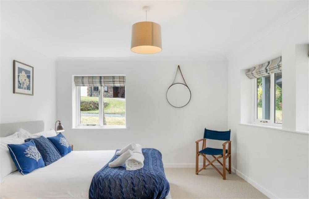 Bedroom one with a 5’ king-size bed, dressing area and en-suite bathroom with overhead shower. at The Hawthorns, St Minver