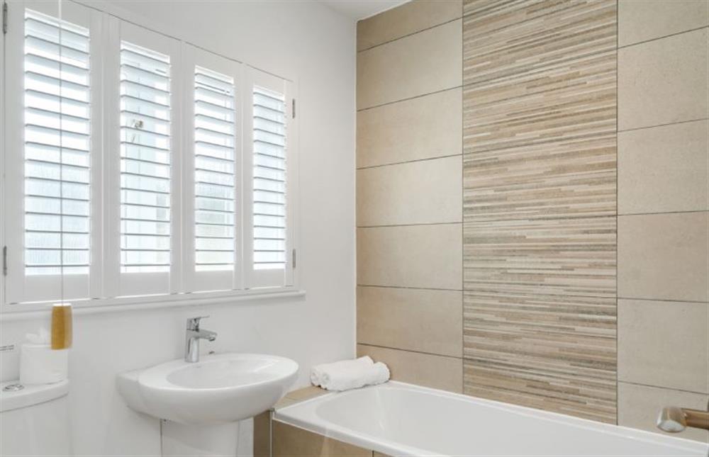 Family bathroom with bathtub, overhead shower, heated towel rail, wash basin and WC. at The Hawthorns, St Minver