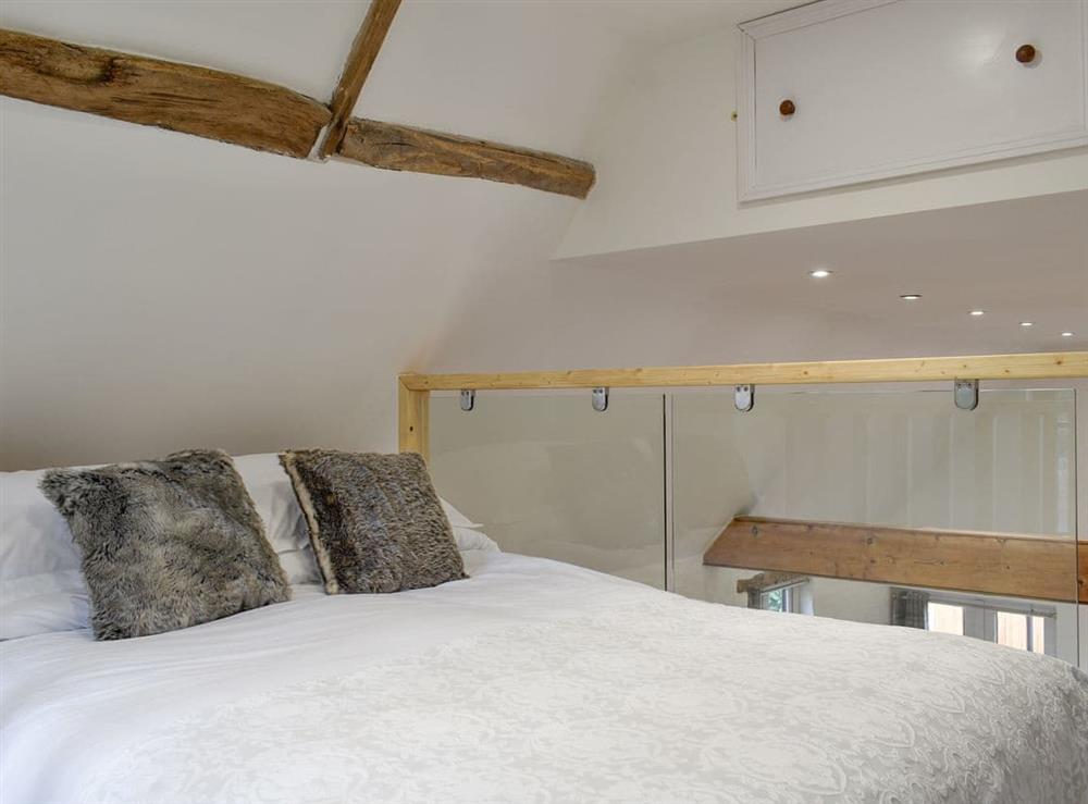 Comfortable double bed on the mezzanine level at The Hay Barn in Beccles, Suffolk
