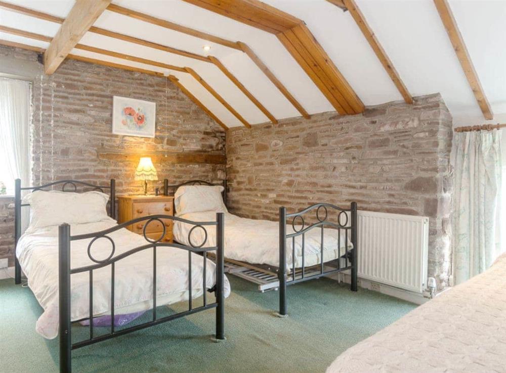 Twin bedroom with an additional single bed at The Haybarn in Devauden, nr Chepstow, Gwent