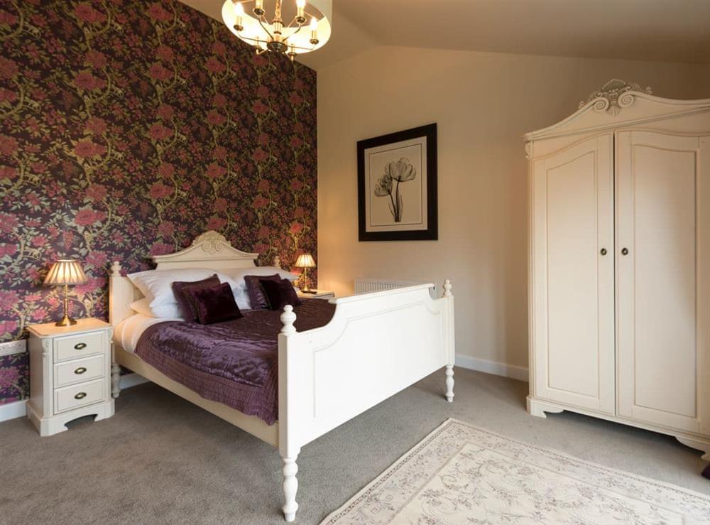 Comfortable bedroom with kingsize bed and Juliet balcony at The Haybarn in Wimbourne, Dorset