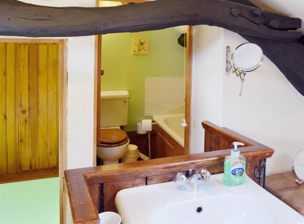 En-suite bathroom with shower over the bath at The Hayloft Barn in near Criccieth, Gwynedd