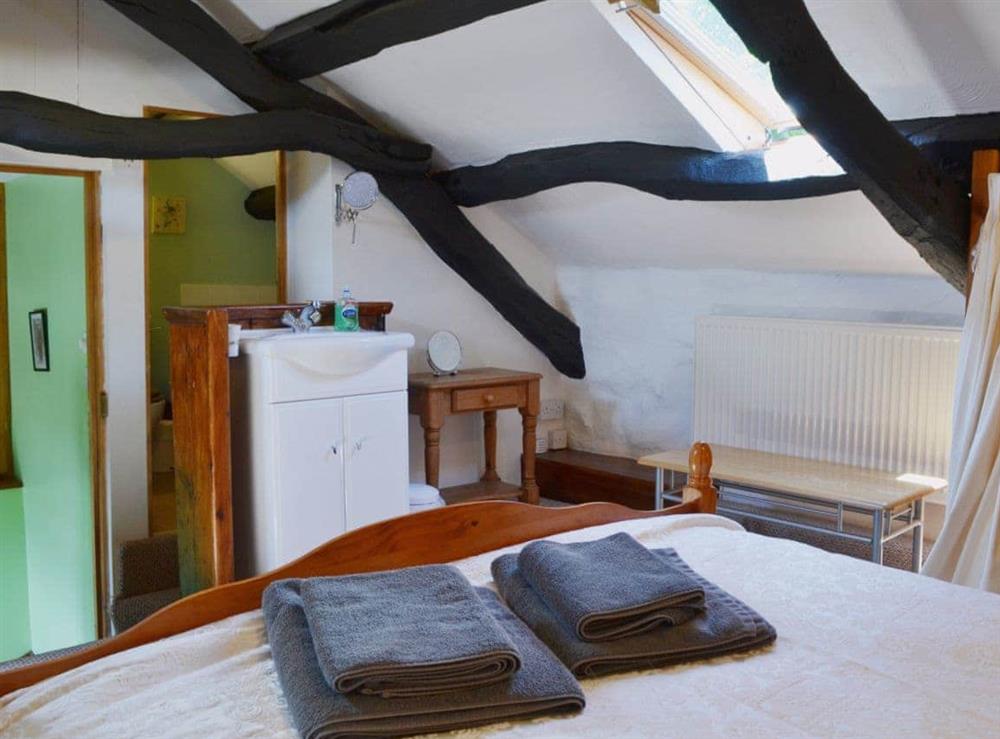 Sloping ceilings and roof lights in the delightful bedroom at The Hayloft Barn in near Criccieth, Gwynedd