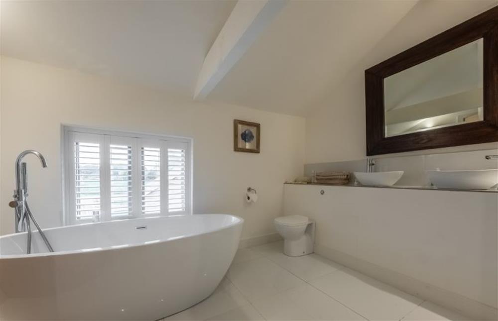 Master en-suite with egg shaped roll top bath...