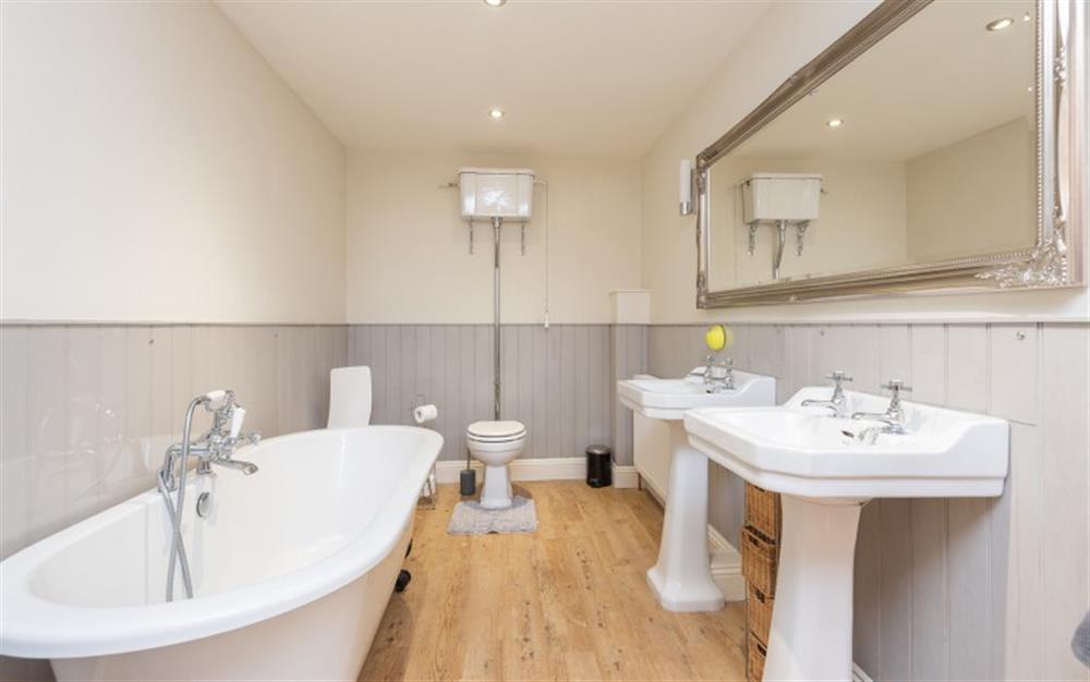 Family bathroom with rolltop bath and separate shower  at The Hayloft in Haytor
