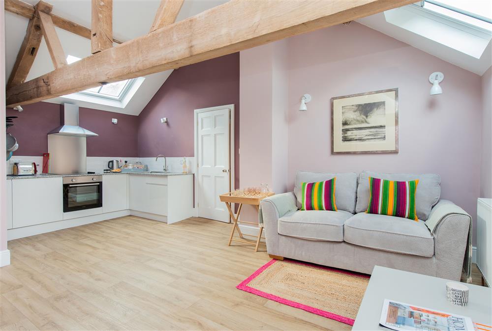 Open plan sitting room and kitchen with exposed beams and rafters at The Hayloft, Monkland nr Leominster