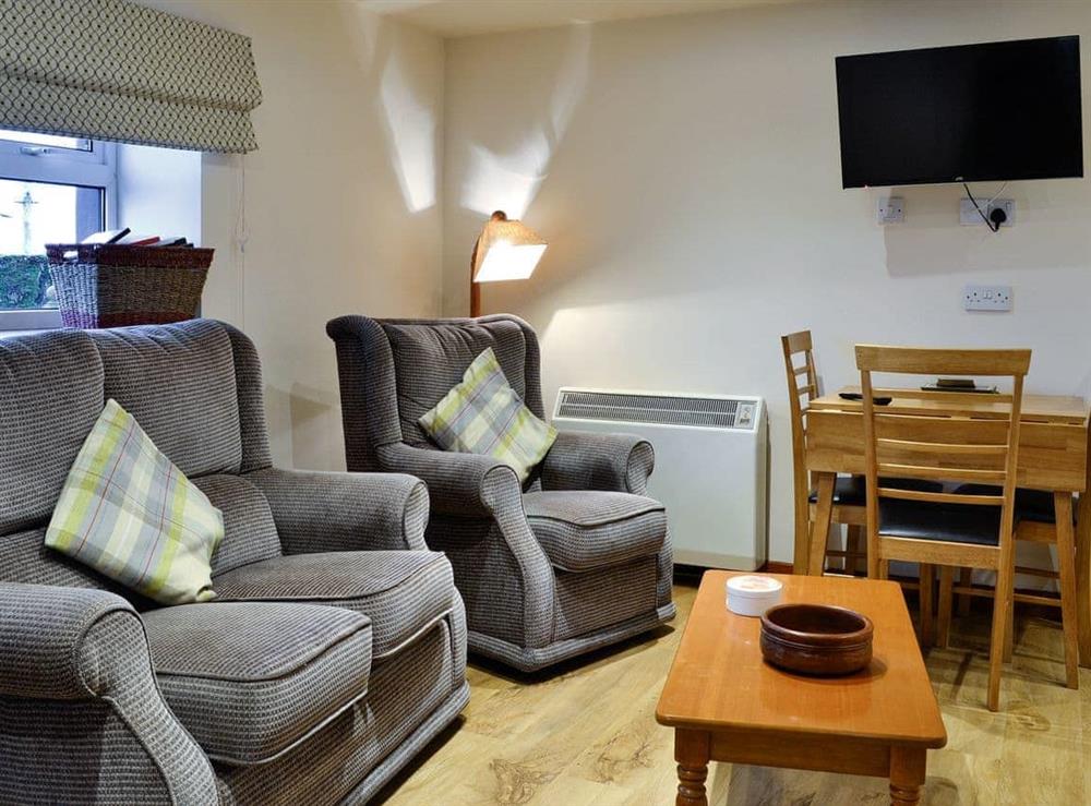 Cosy living area of open-plan living space at The Hayloft in Stranraer, Wigtownshire