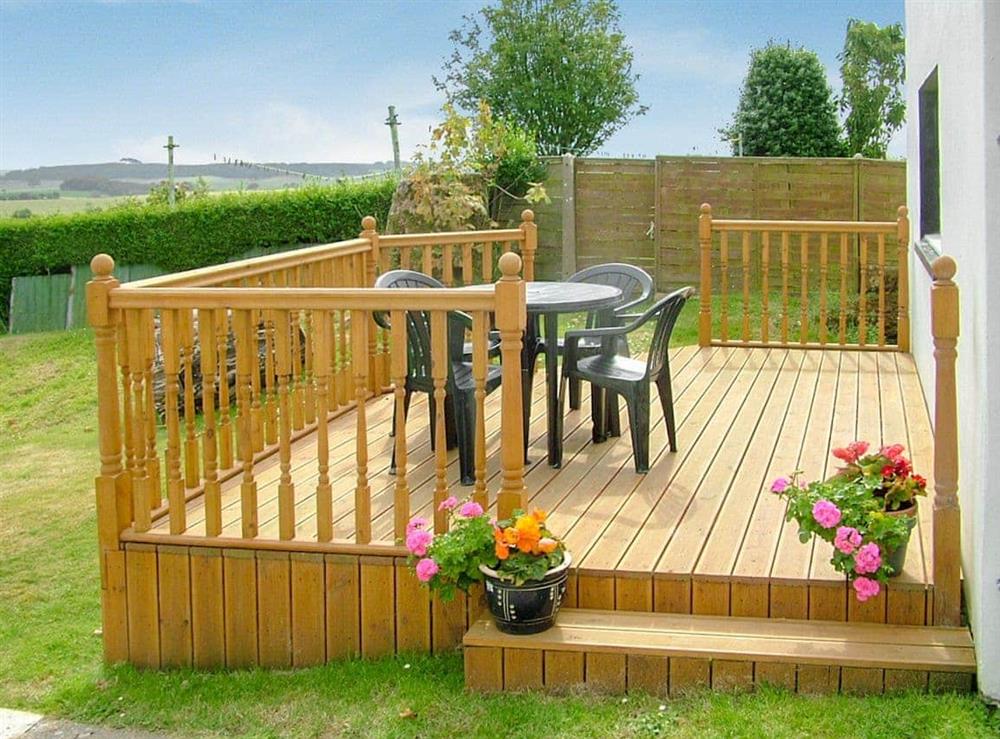 Decking/ sitting out area in the garden at The Hayloft in Stranraer, Wigtownshire