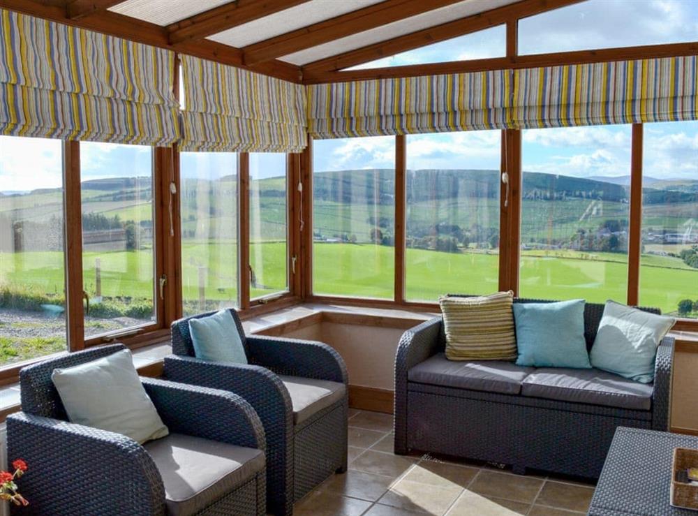 Conservatory with views of the surrounding countryside at The Hen Hoose in Langshaw, near Galashiels, Selkirkshire