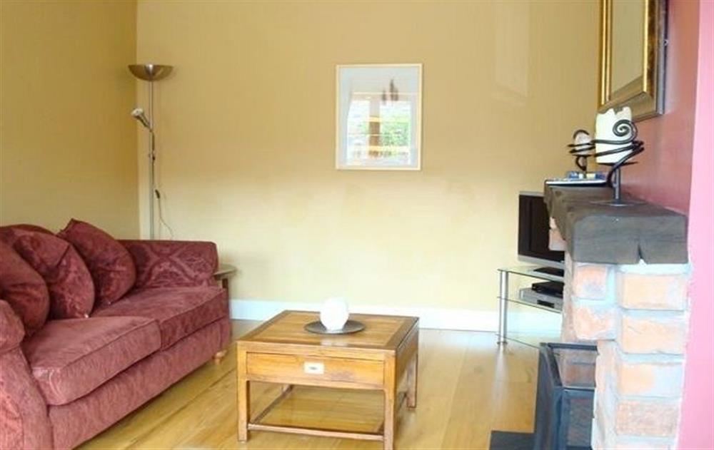 Ground floor:  Spacious living room with oak floors and multi-fuel stove (photo 2) at The Hen House, Navan