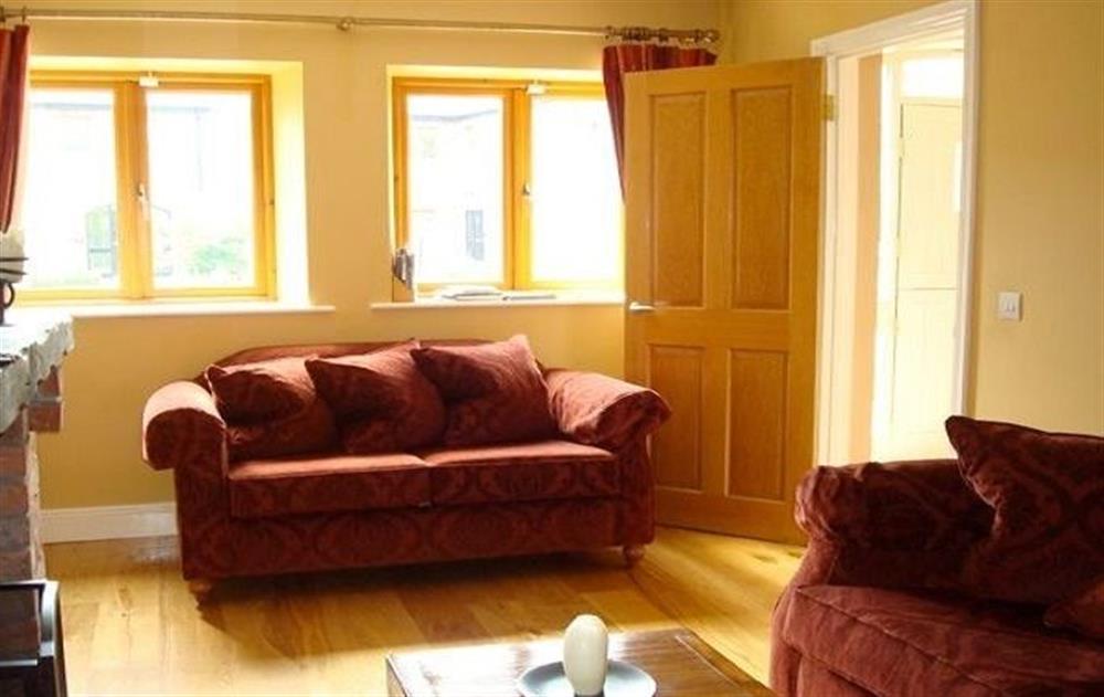 Ground floor:  Spacious living room with oak floors and multi-fuel stove at The Hen House, Navan