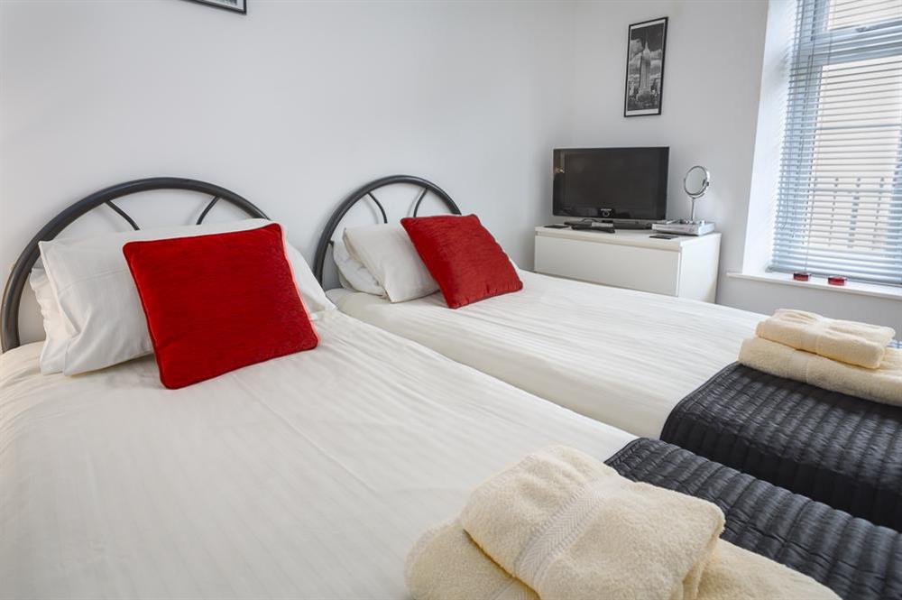 Ground floor bedroom with two single beds at The Hideaway in , Dartmouth