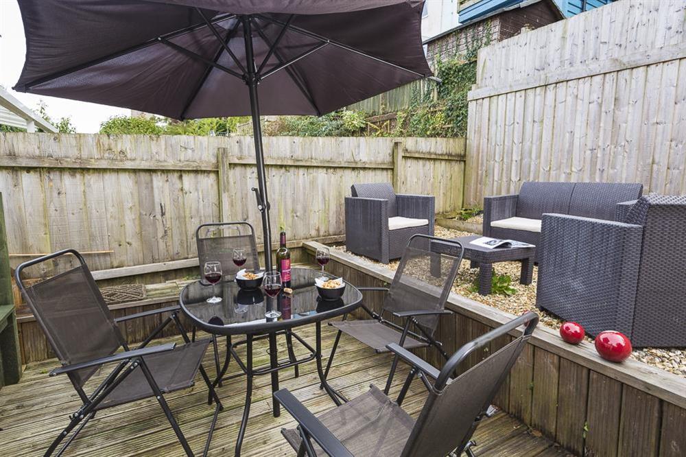 Sunny decking with a bistro table and four chairs at The Hideaway in , Dartmouth