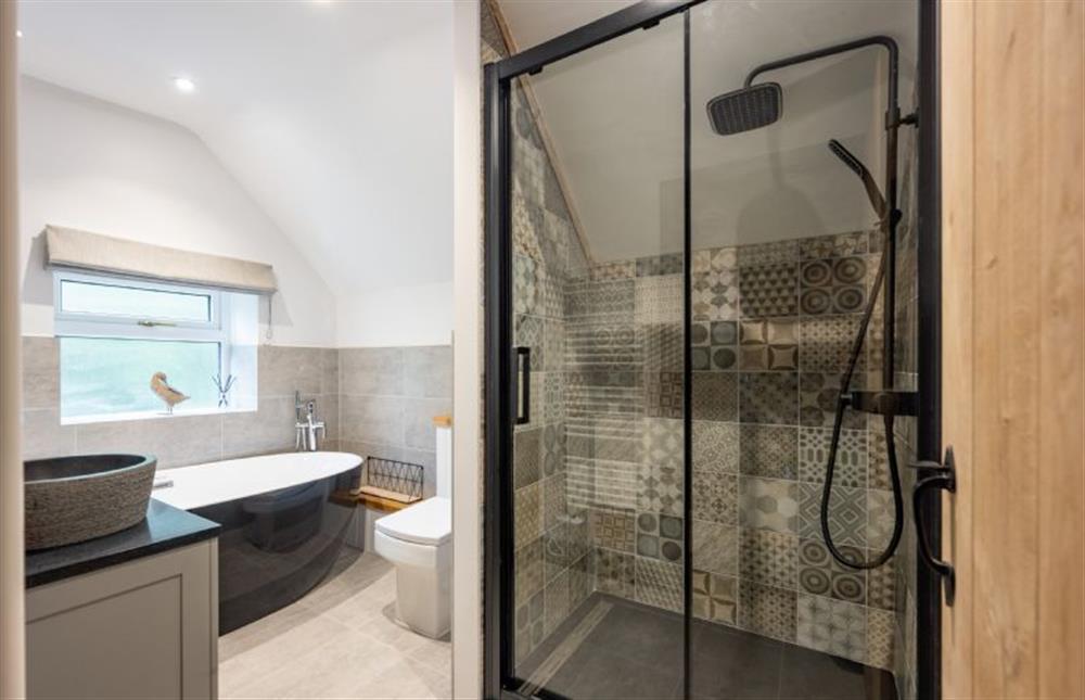 First floor: The bathroom has a shower and fabulous bath at The Hideaway, Great Massingham near Kings Lynn