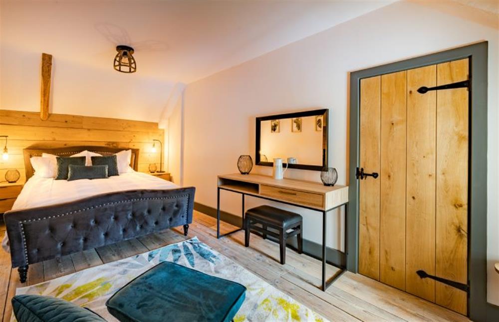 First floor: The bedroom has king-size bed at The Hideaway, Great Massingham near Kings Lynn