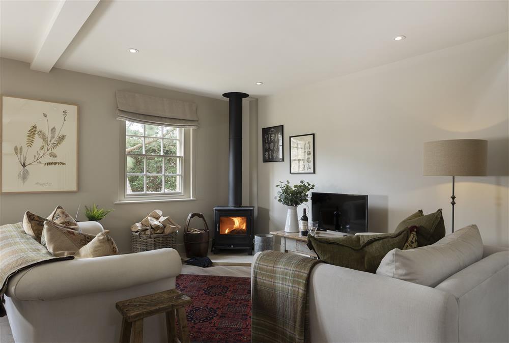 Comfy sitting room with cosy wood burning stove at The Hideaway,  Lower Oddington