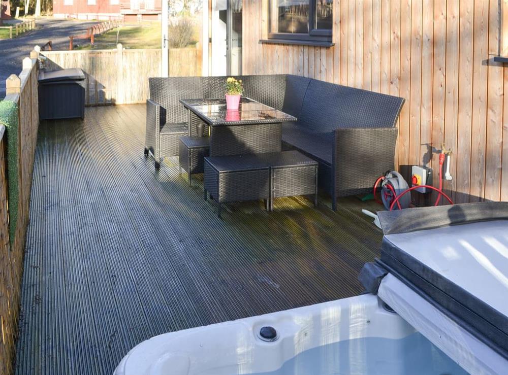 Outdoor area with hot tub at The Hideaway in Otterburn, near Bellingham, Northumberland