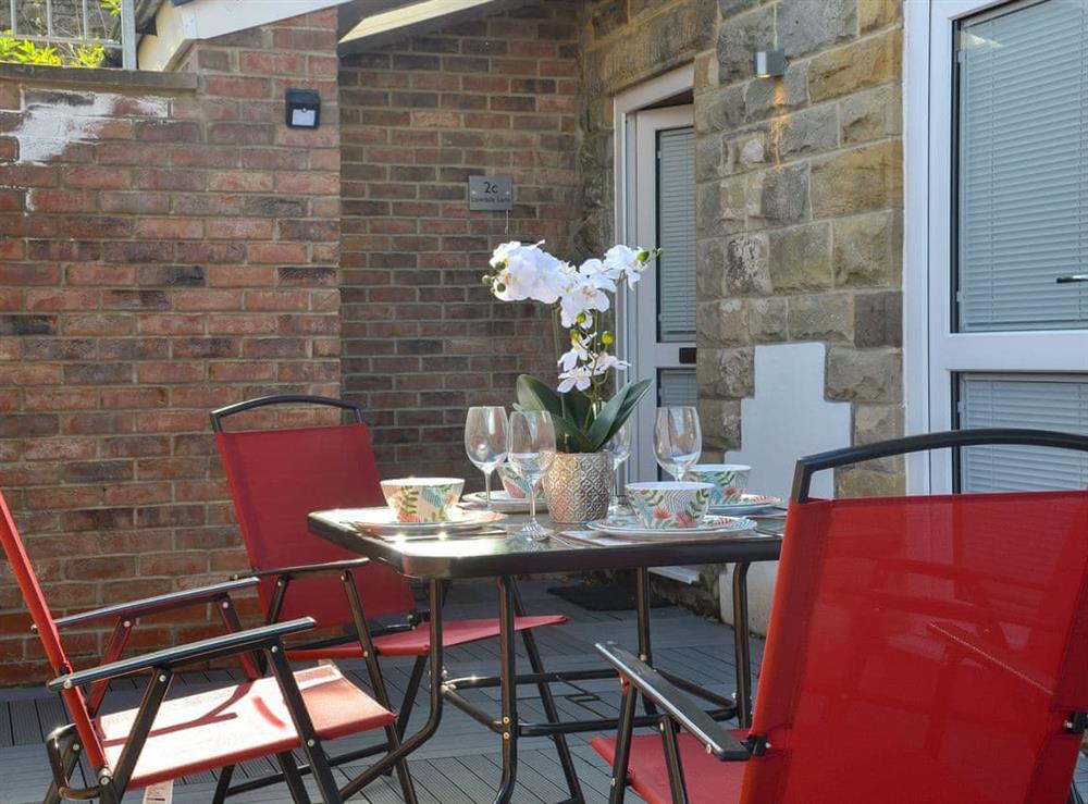 Enclosed sitting-out area with garden furniture at The Hideaway in Sleights, near Whitby, North Yorkshire