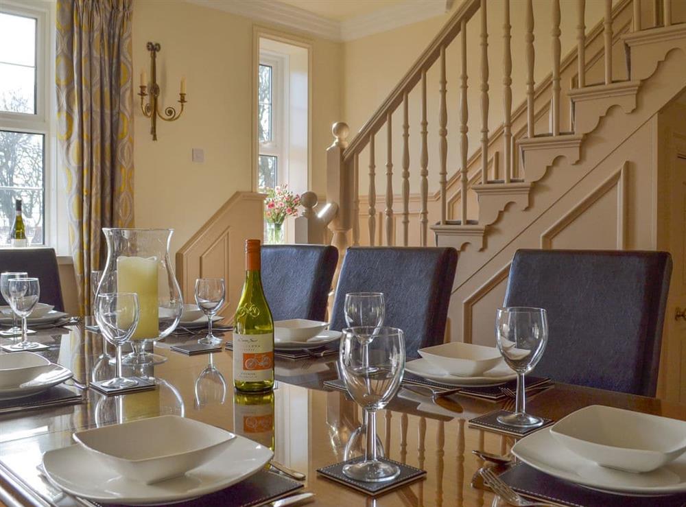 Elegant dining room with stairs to first floor at The Hind House in Cottam, near Driffield, North Humberside