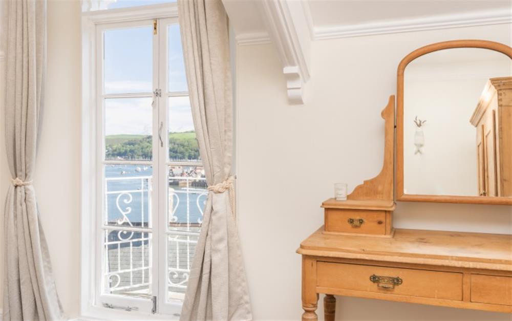 View of the master bedroom's dressing table and french doors to balcony. at The Holt in Dartmouth