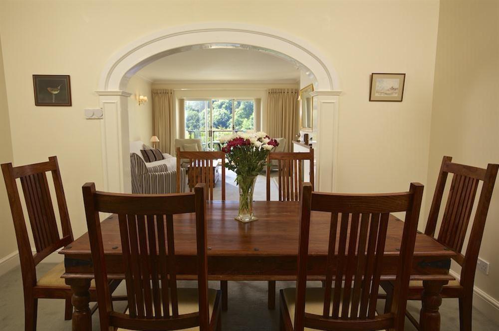 Alcoved dining area with large table and chairs at The Hoot in Sandhills Road, Salcombe