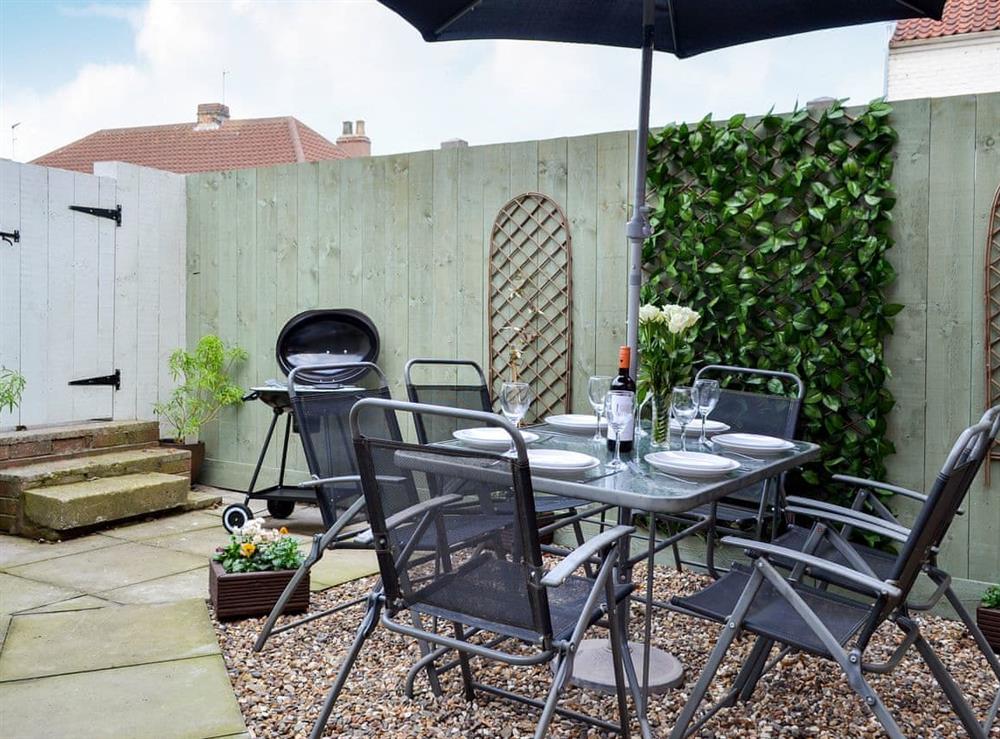 Small enclosed courtyard with sitting-out area, garden furniture and BBQ (photo 2) at The Horseshoes in Hornsea, North Humberside